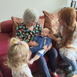 Dawn Crawford holding her newest great-grandchild Lucien, with her granddaughter beside her in Port Stephens.